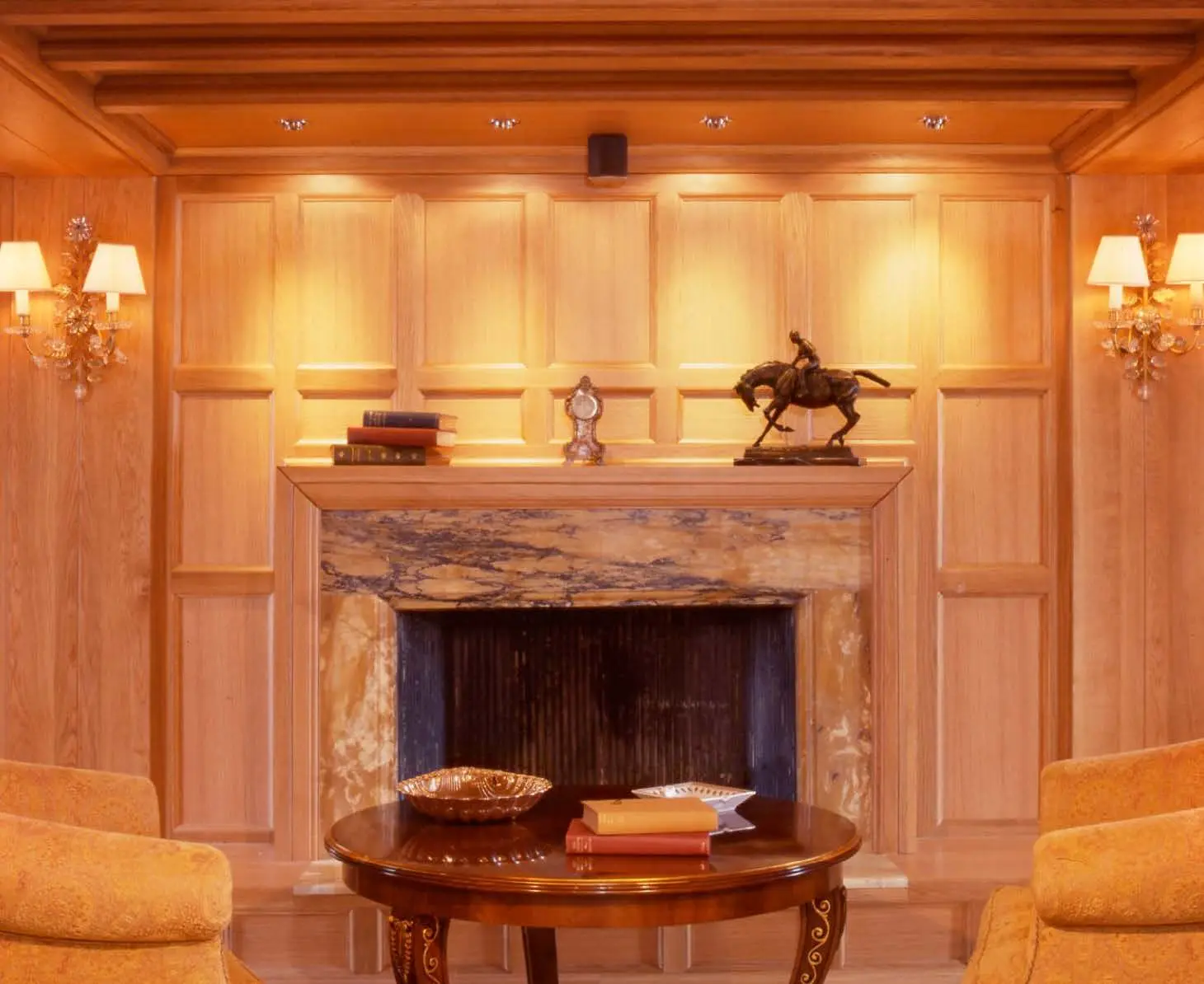 Fireplace set into timber panelling with decorative surround