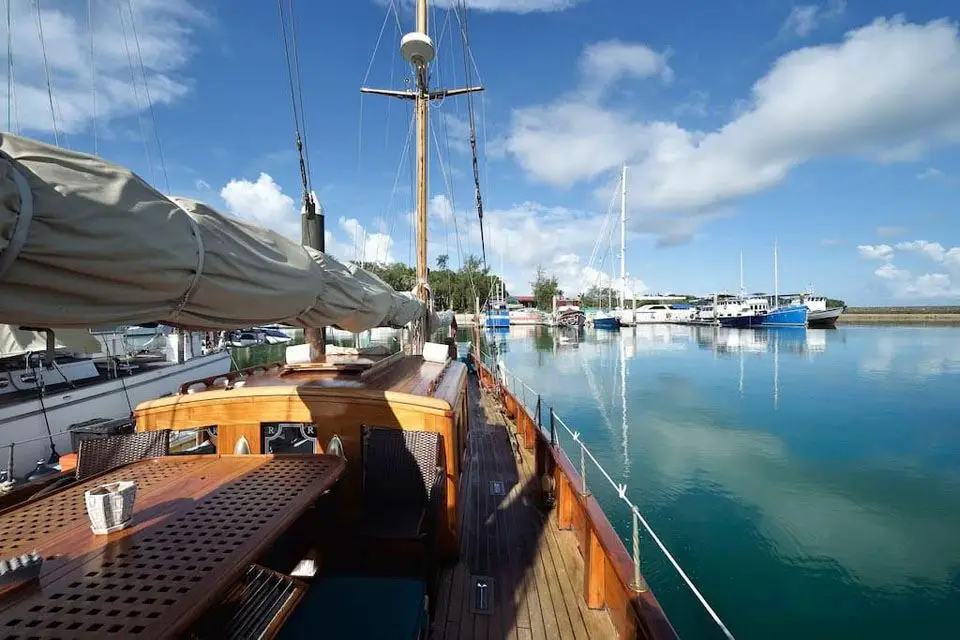 Rona's deck saloon top and dining table looking aft over calm water