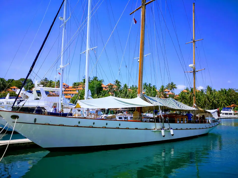 Rona moored broadside in a marina under a clear sky