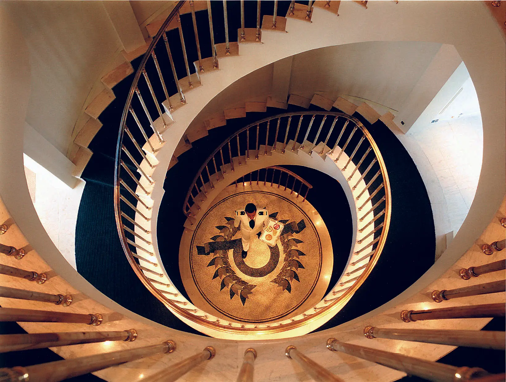 Spiral staircase connecting decks, with polished handrail