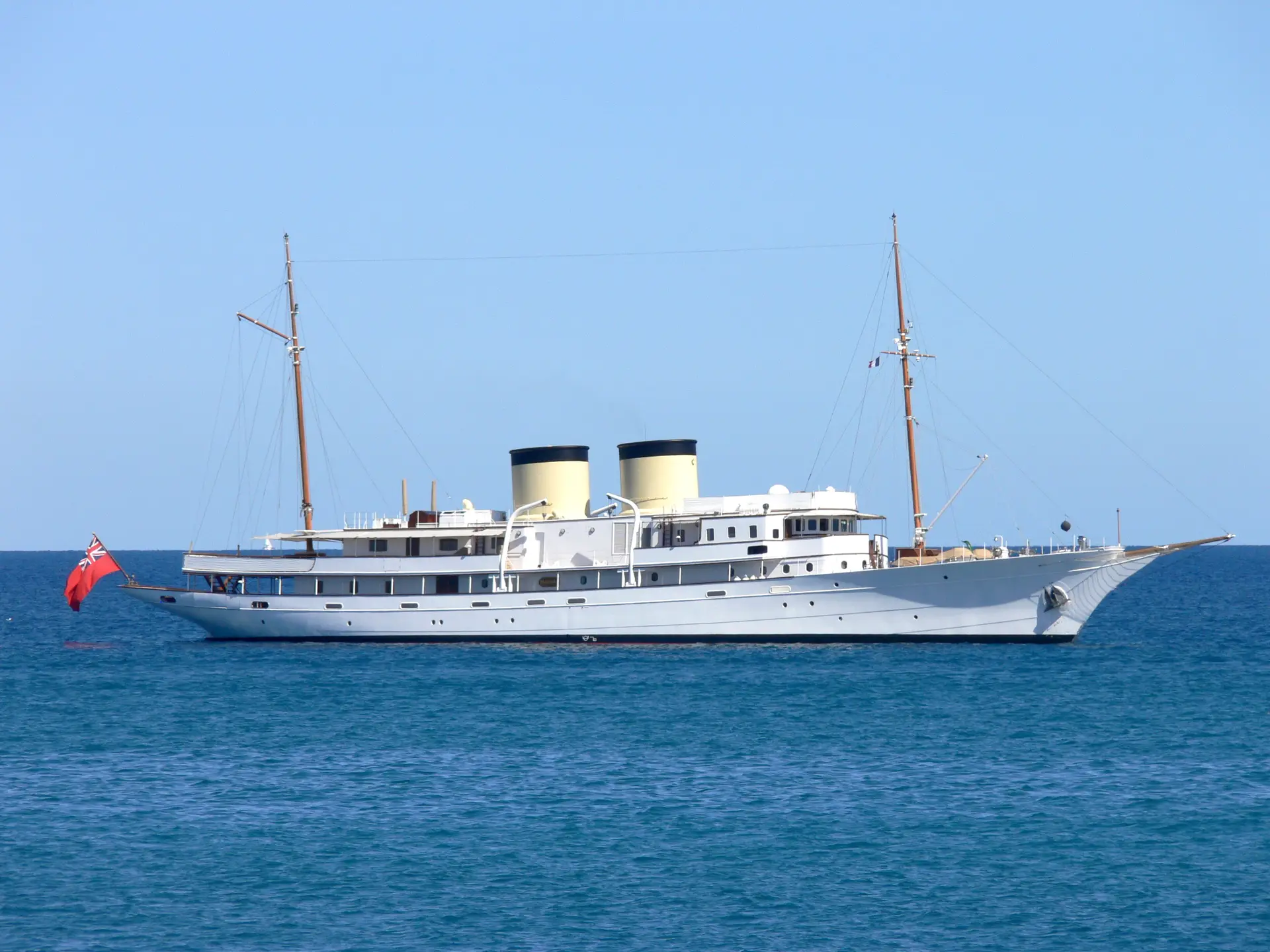 Port profile of Talitha at anchor in deep blue water