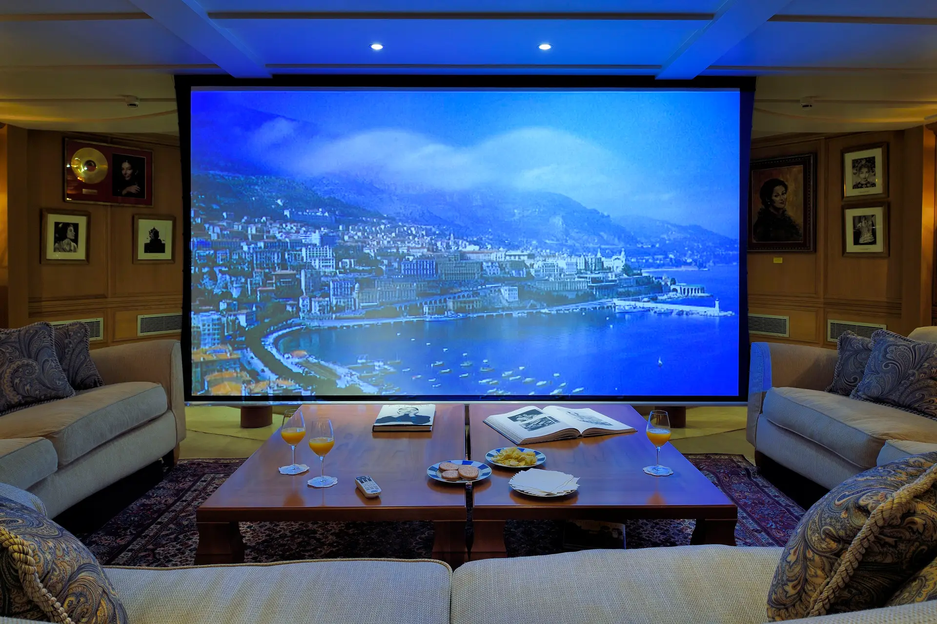 Cinema lounge with tiered seating and a screen