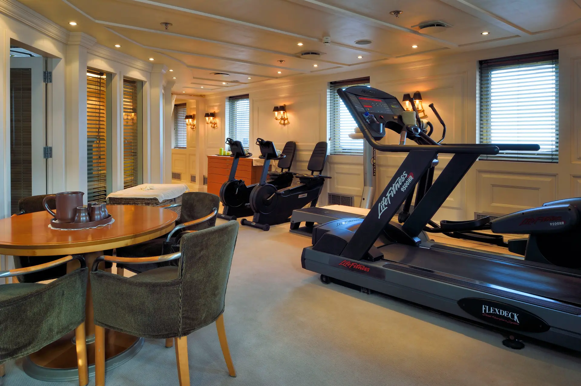 Gymnasium with exercise equipment and windows