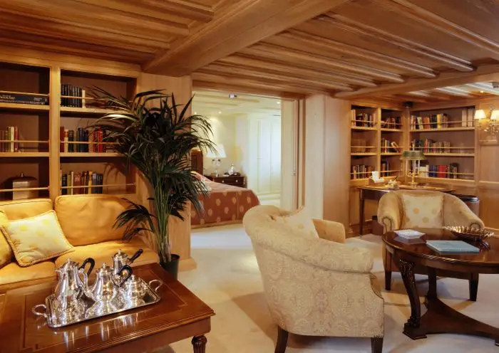 Sitting room within a guest suite, with sofa and side tables