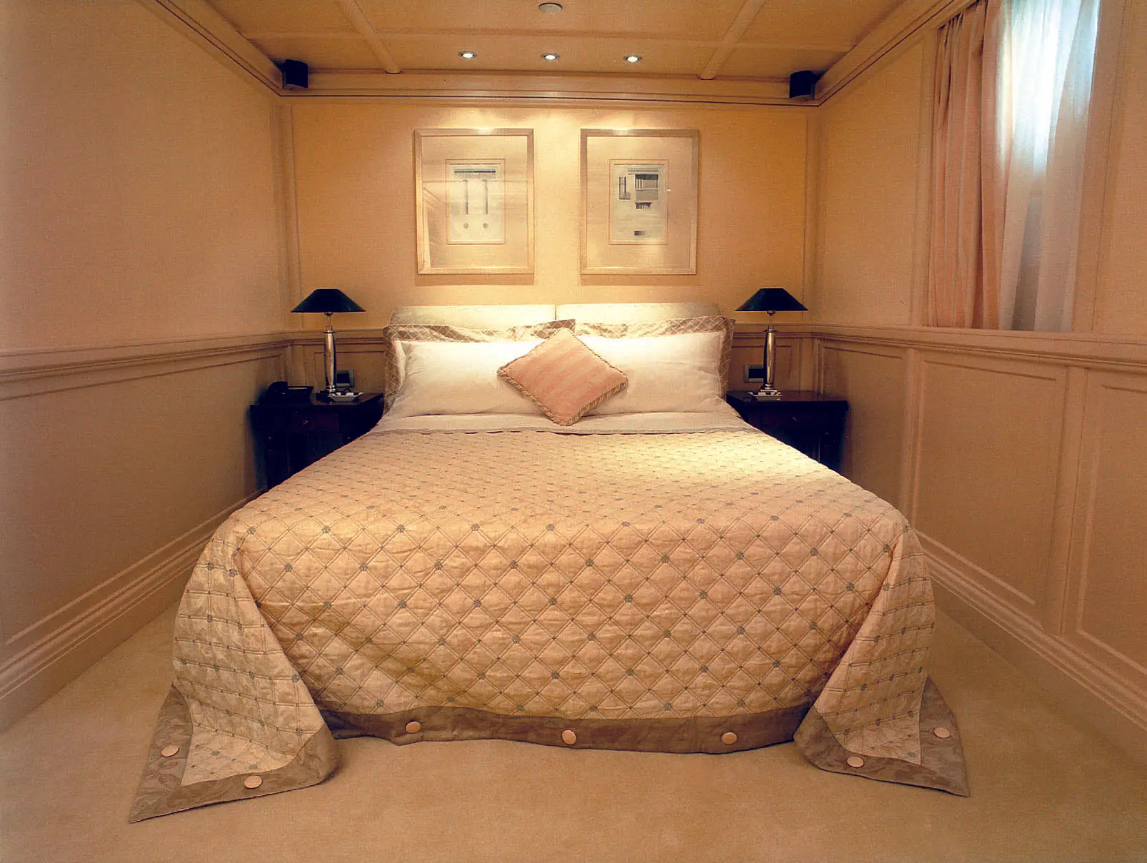 Master cabin with a double bed, panelled bulkheads and windows