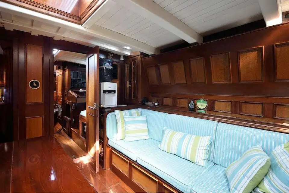 Saloon settee beside an open panelled door leading forward